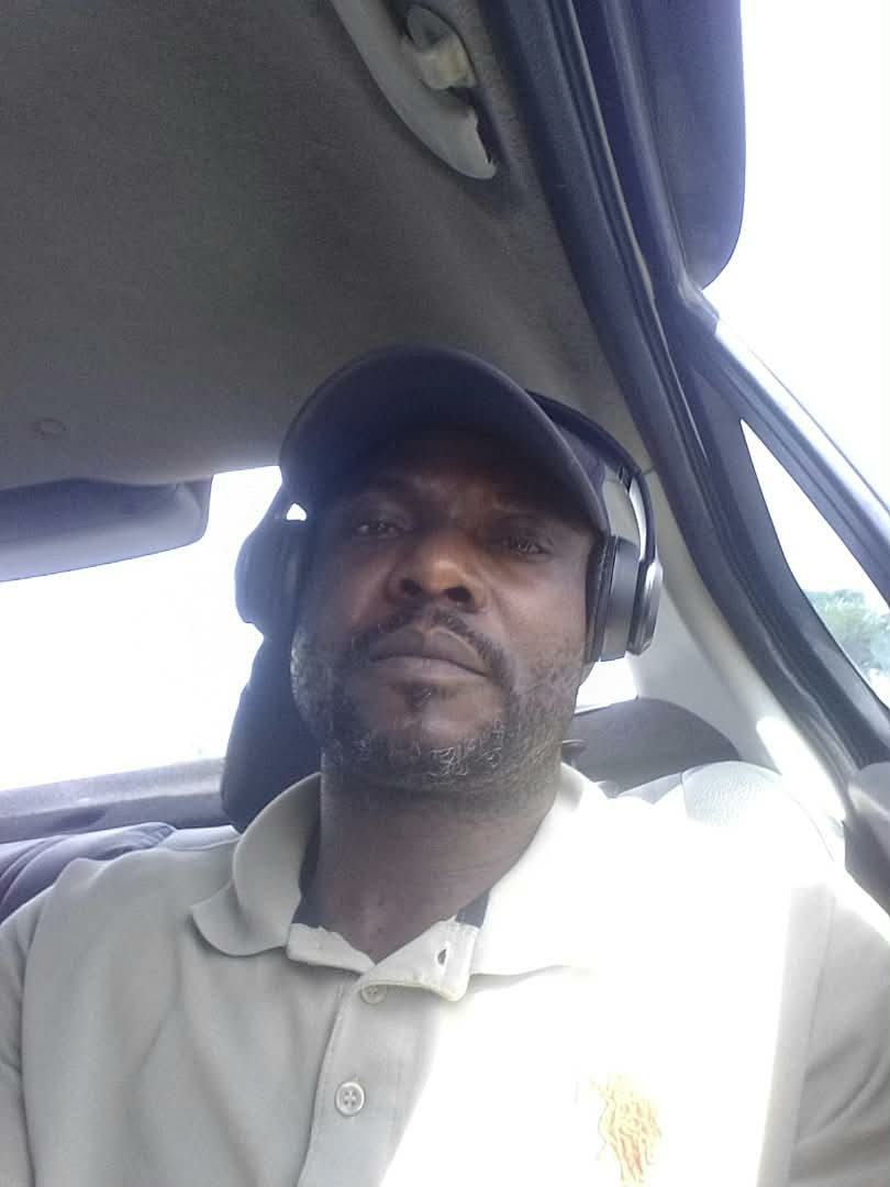 In a car, cap and headphones