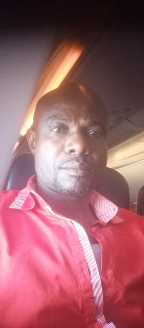 On a plane, red shirt
