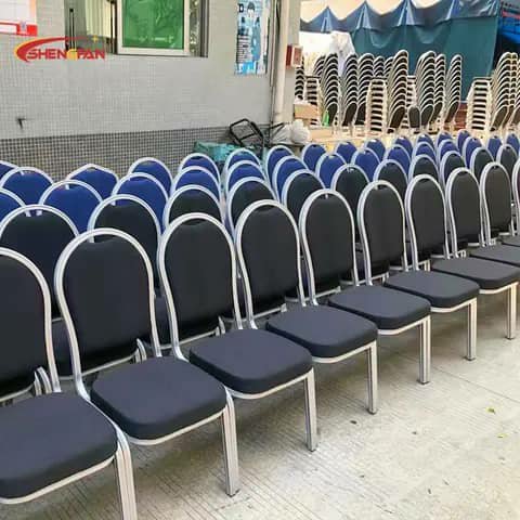 Rows of black banquet chairs with silver frames