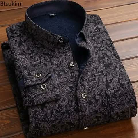 A folded black shirt with a paisley print.