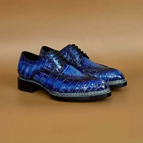 Blue derby shoes with a croc pattern.