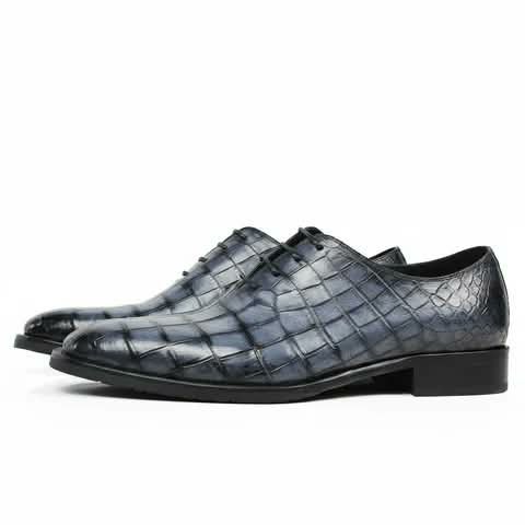 Blue-grey Oxford shoes with a croc pattern.