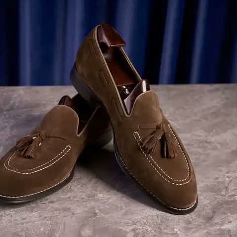 Brown suede loafers with tassels.