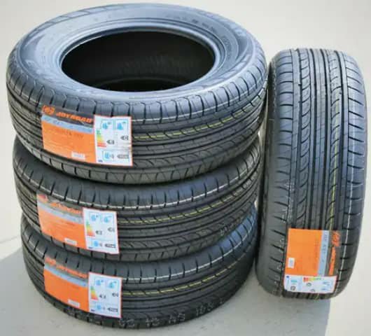 Four car tyres with orange labels