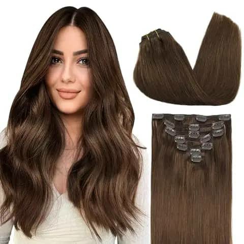 A woman with long wavy brown hair beside clip-in hair extension pieces in brown.