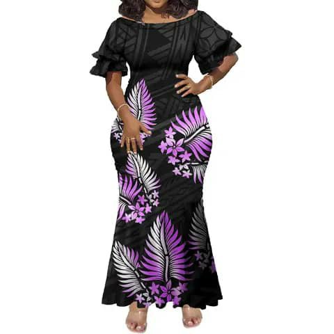 A woman wearing a long black dress with a purple and white floral print and off-shoulder ruffle sleeves.