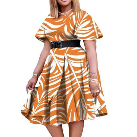 A woman wearing an orange-and-white leaf-print flared dress with a black belt.