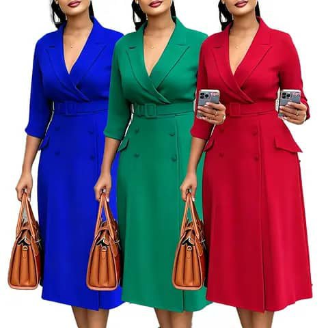 Three women wearing long blazer-style dresses in blue, green and red with belts, holding handbags.