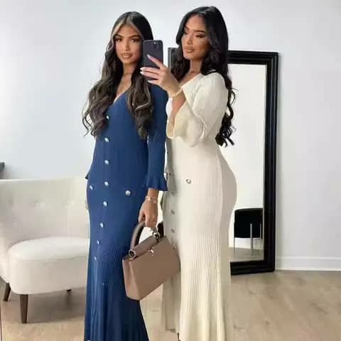 Two women wearing long ribbed button-front dresses in blue and ivory, taking a mirror selfie.