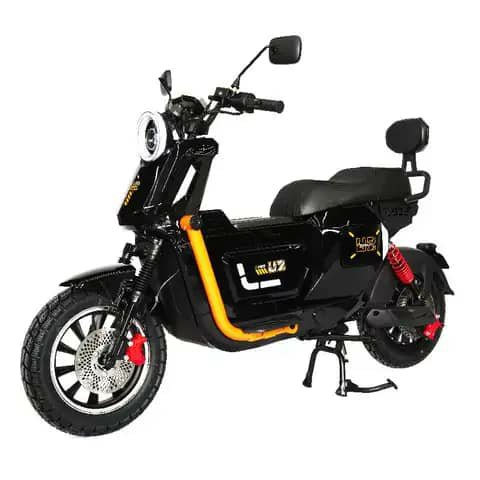Black electric scooter with orange stripe, studio shot