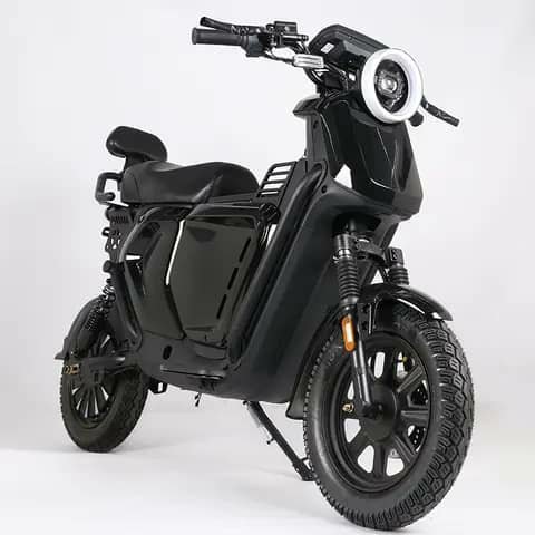 Black electric scooter with round headlight, studio shot
