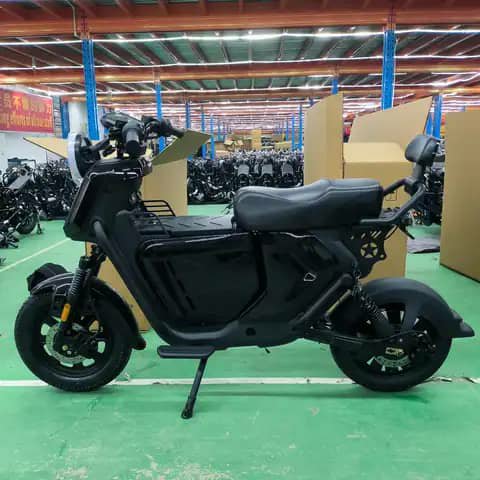 Black electric scooter in a warehouse of scooters