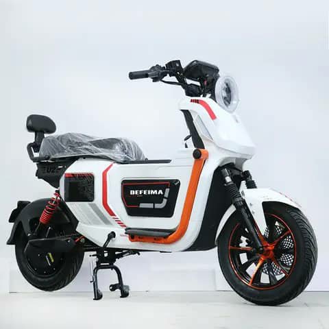 White and orange electric scooter, studio shot