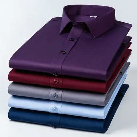 Folded dress shirts stacked in five colours.