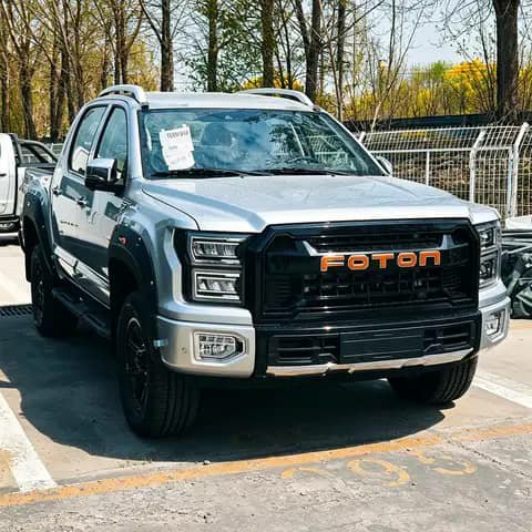 Silver Foton pickup, orange grille badge
