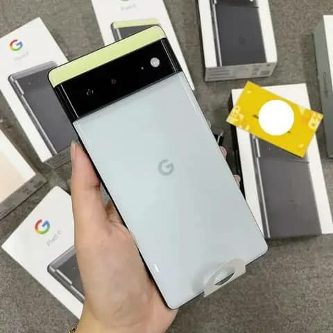 White Google Pixel 6 held up, box behind