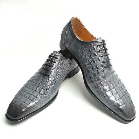 Grey Oxford shoes with a croc pattern.