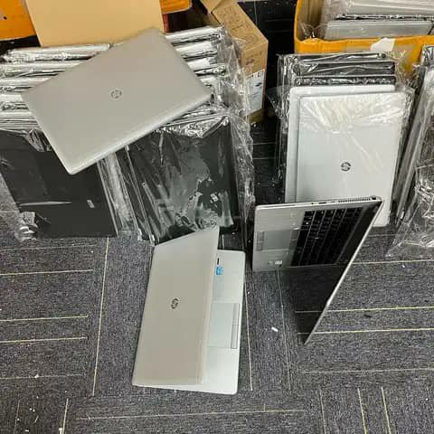 HP laptops wrapped, stacked in silver and black