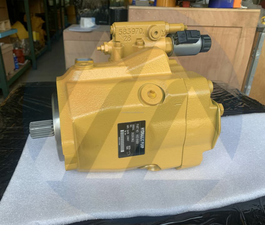 A yellow hydraulic pump with a black plate and splined shaft, on white foam.