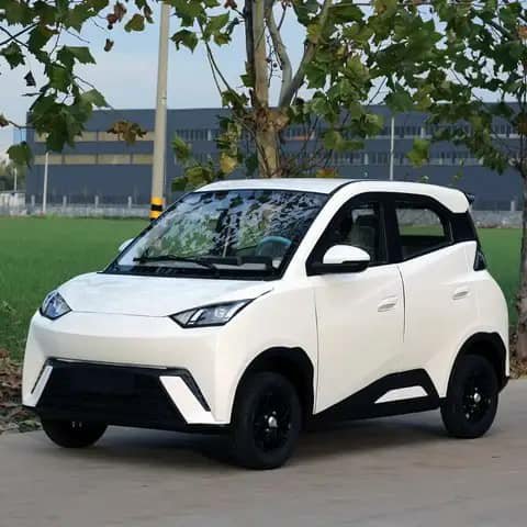 Small white micro EV city car parked outdoors