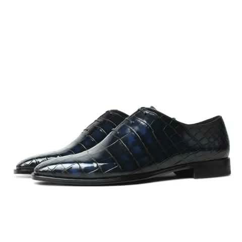 Navy lace-up shoes with a croc pattern.
