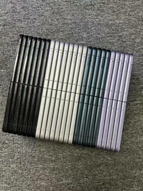 Rows of smartphones showing their backs in black, white, silver, green and lilac