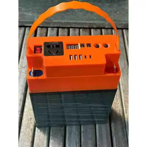 Orange portable power bank with handle and outlets