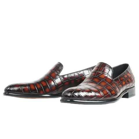 Slip-on shoes with a red-brown croc pattern.