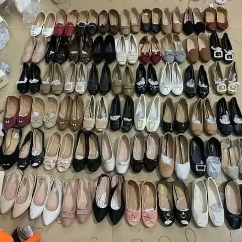 Rows of women's flat shoes in many styles and colours.
