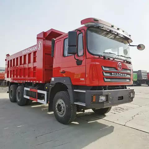 Red Shacman dump truck parked outdoors