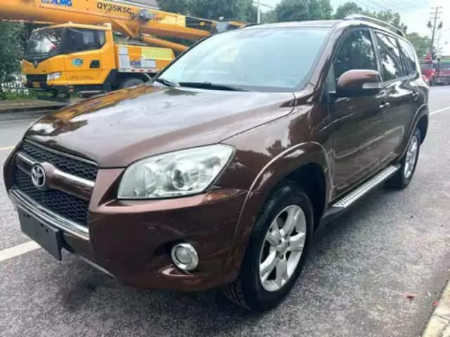 Brown Toyota RAV4 SUV on a street