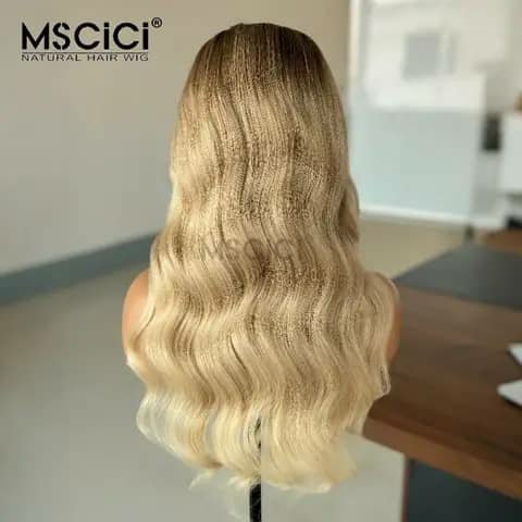 The back view of a long wavy blonde wig on a mannequin head.