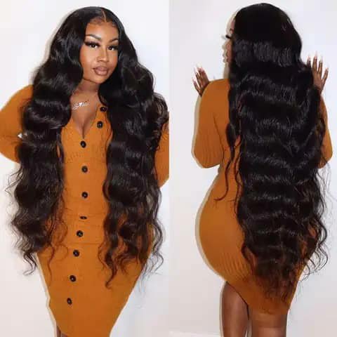 Two views of a woman wearing a very long dark body-wave wig in a mustard dress.