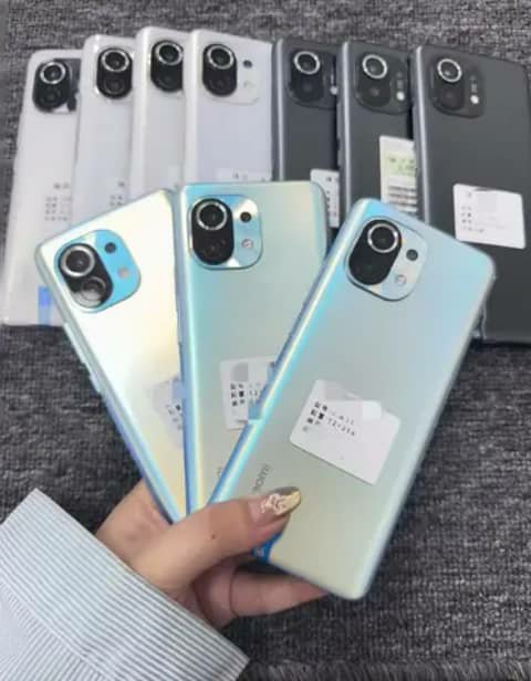 Xiaomi smartphones held up in white and blue-grey